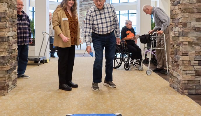 Residents and staff engaged in an activity in the common area