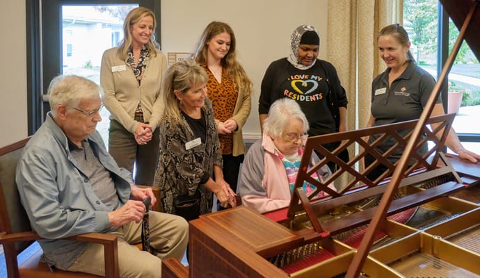 Residents and staff engaging in a musical activity