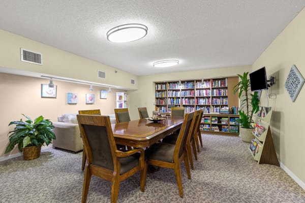 Common area with large dining table and bookshelves