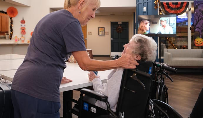 Staff member assisting resident in a common area