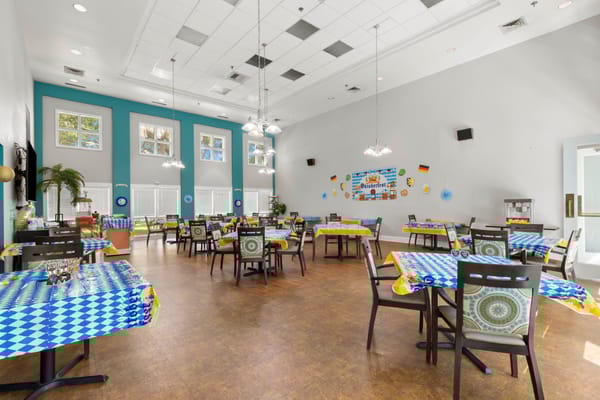 Dining room with colorful tables set for residents