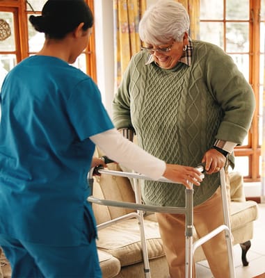 A staff member assisting a resident with a walker