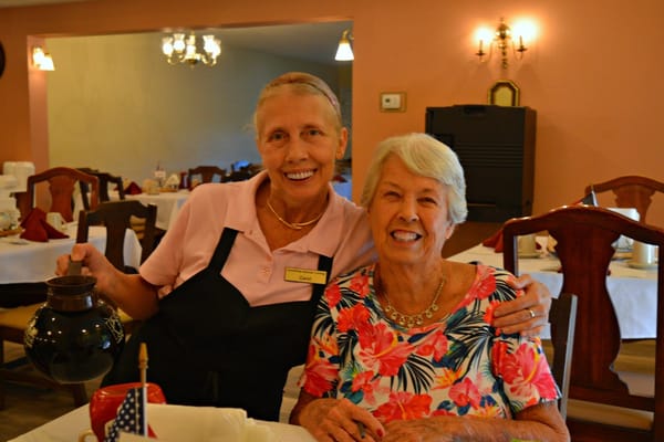 Staff member serving a resident in the dining room