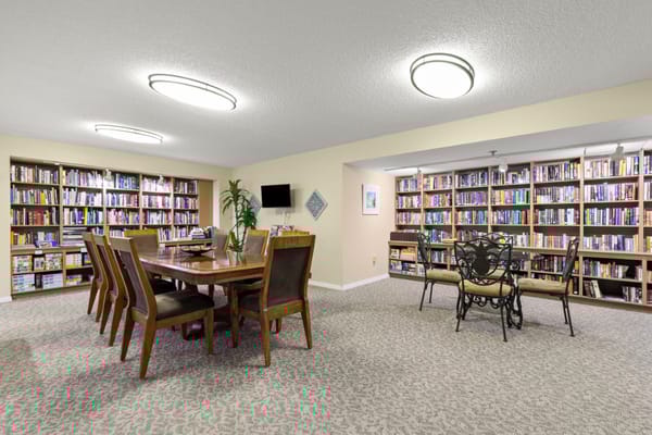 Common area with bookshelves and dining table