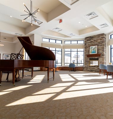 Bright and spacious common area with a piano