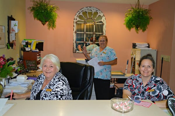 Staff members at a reception desk in a care facility