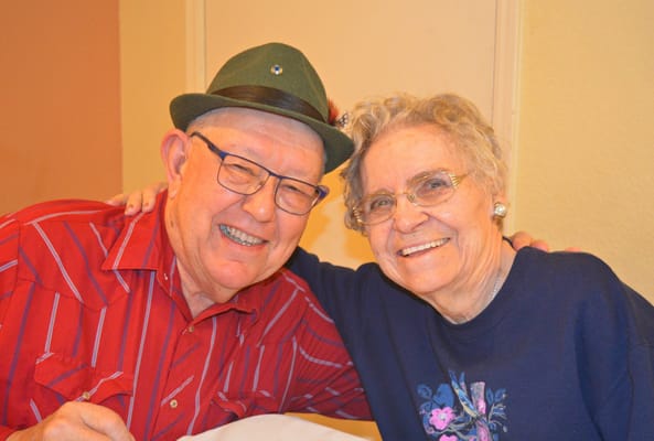 Senior couple smiling together at a table