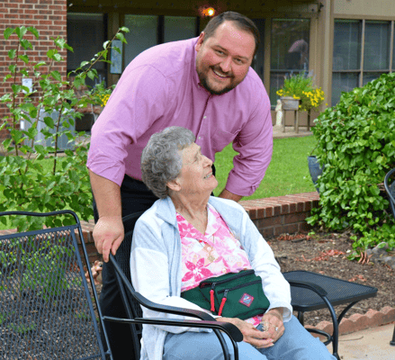 A staff member interacting with a resident outdoors