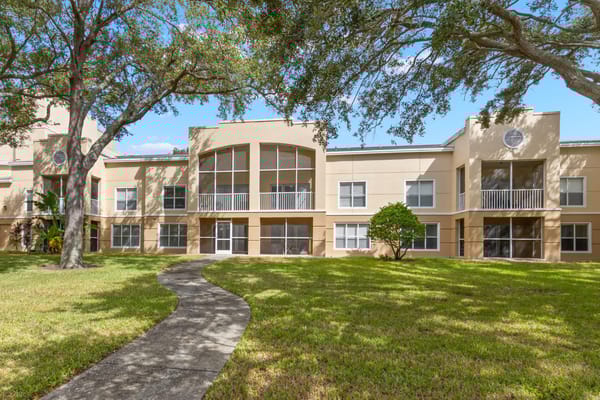 Exterior view of The Barrington facility with landscaped space