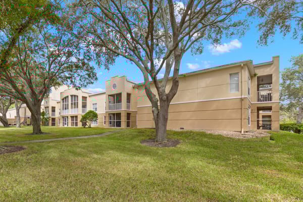 Exterior view of a senior living facility surrounded by trees