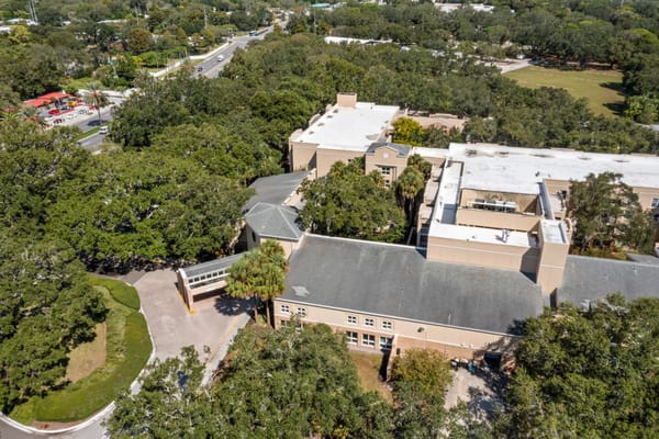 Aerial view of the senior living facility surrounded by trees