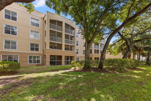 Exterior view of a senior living facility surrounded by trees