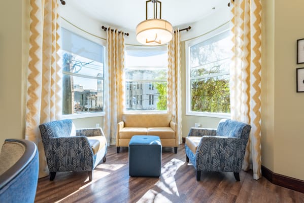 Bright common area with cozy seating by large windows