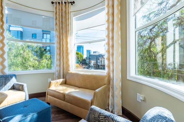 Cozy seating area with large windows and natural light