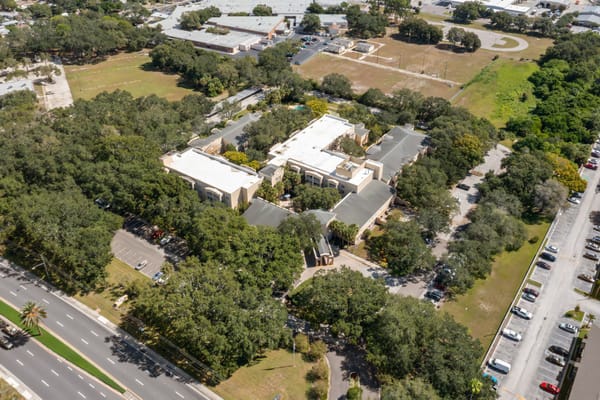 Aerial view of the senior living facility surrounded by trees