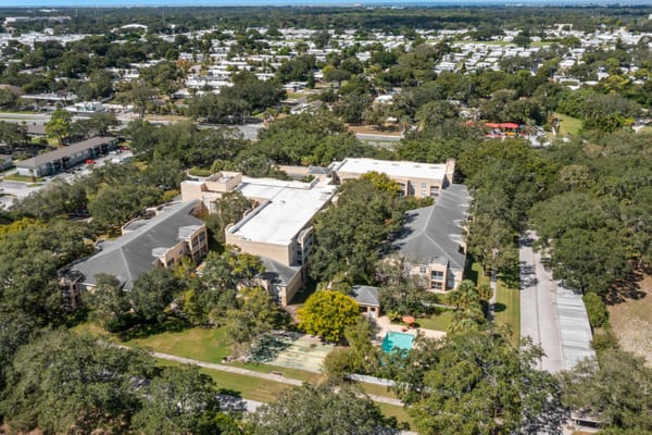 Aerial view of a senior living facility surrounded by trees