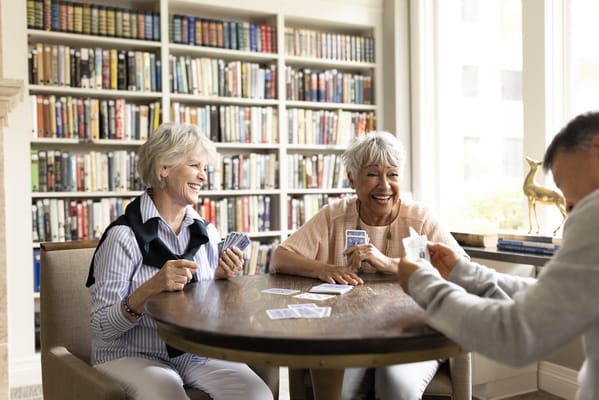 Residents enjoying a card game in the library