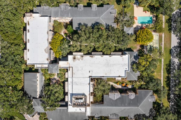 Aerial view of the assisted living facility surrounded by trees and outdoor space.