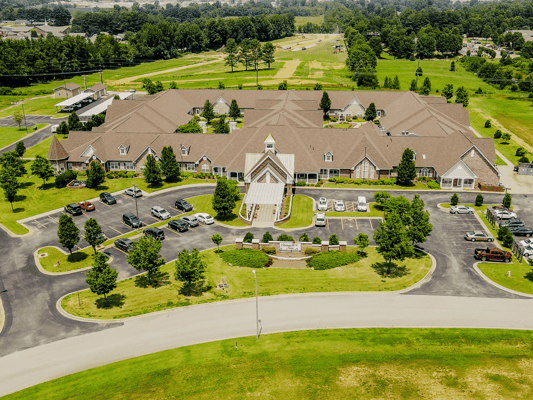 Aerial view of Chateau On The Ridge facility with surrounding greenery