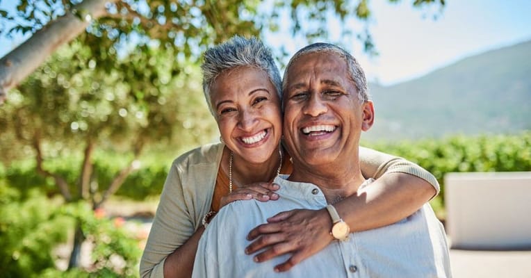 A happy senior couple outdoors, smiling together