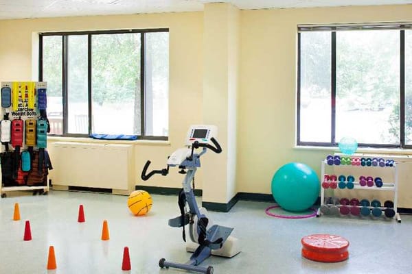 Interior exercise room with fitness equipment and balls