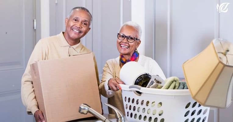 Residents smiling while moving in with personal items