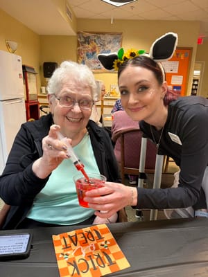 Resident and staff member engaging in an activity