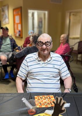 Happy resident wearing fun glasses during an activity