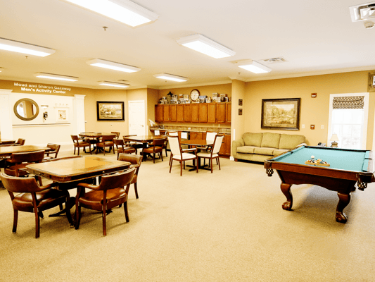 Interior view of a common area with pool table and seating
