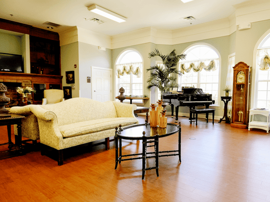Bright interior common area with seating and piano