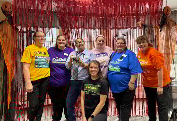 Staff and residents in Halloween costumes at the facility