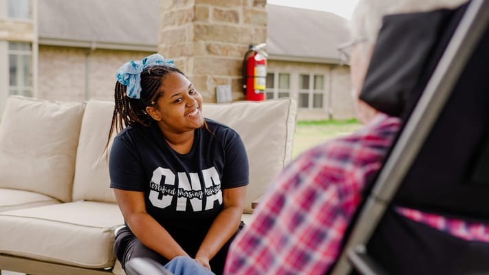 Staff member engaging with a resident outdoors