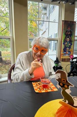 Resident enjoying a festive activity with dessert