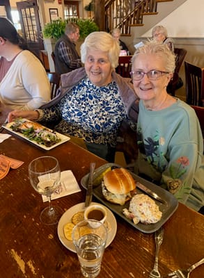 Two residents enjoying a meal in the dining room