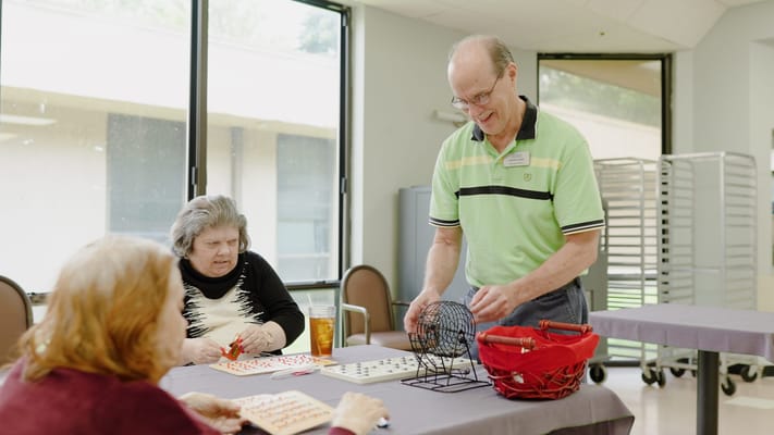 Residents playing bingo in a common area