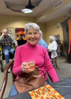Resident enjoying a festive gathering in the activity room