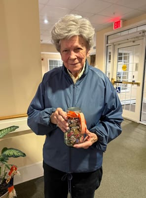 Resident holding a jar of candies in a common area