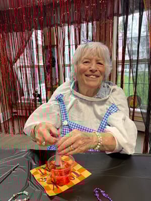 A resident enjoying an art activity in a common area