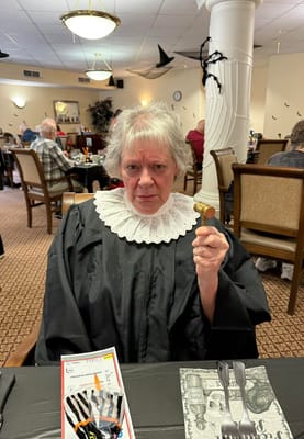 Resident dressed as a judge holding a gavel