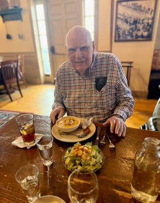 A resident enjoying a meal in a dining room