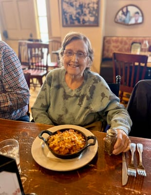 Resident enjoying a meal in a cozy dining space