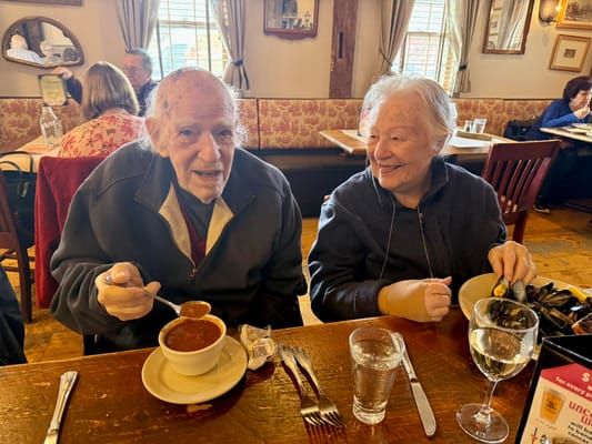 Two residents enjoying a meal together in a dining area