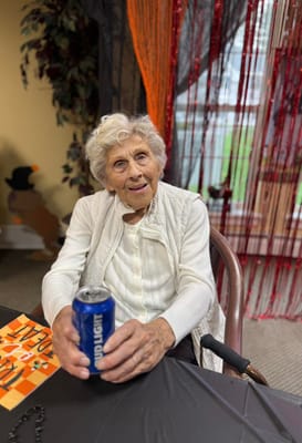 Resident enjoying a drink at a festive gathering