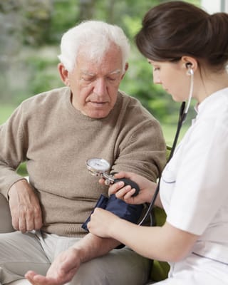 Nurse taking a senior's blood pressure