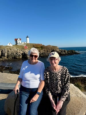 Two residents enjoying the outdoors near a lighthouse