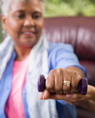 Resident engaging in an exercise activity with dumbbells