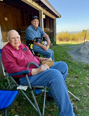 Two residents relaxing outdoors in seating