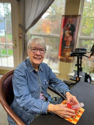 A resident smiling while sitting at a table