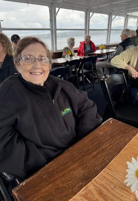 Resident smiling in a common area on a boat outing