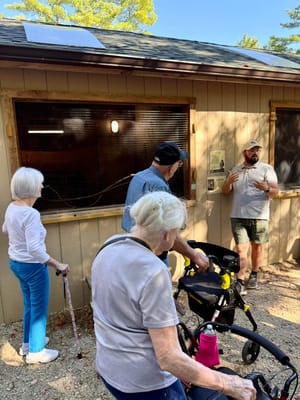 Residents engaging with staff outside a facility